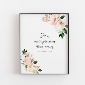 May include: A white printable art print with a floral design in shades of pink and green. The print features the quote "She is more precious than rubies." with the scripture reference "Proverbs 3:15".