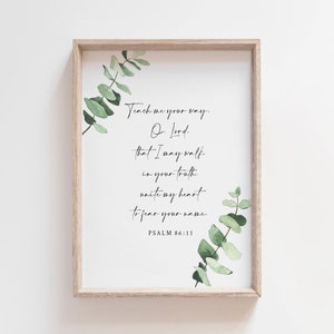 May include: A framed print with a white background and a green eucalyptus branch on the right side. The print features a bible verse from Psalm 86:11, "Teach me your way, O Lord, that I may walk in your truth; unite my heart to fear your name."
