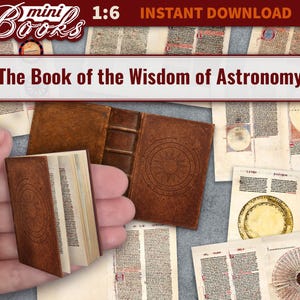 May include: Miniature brown leather-bound book titled "The Book of the Wisdom of Astronomy" with a sunburst design. Several pages of the book are open, revealing printed text. Other pages and a closed book are also visible.