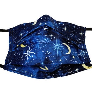 May include: A blue face mask with a celestial print featuring stars, moons, and a galaxy design.