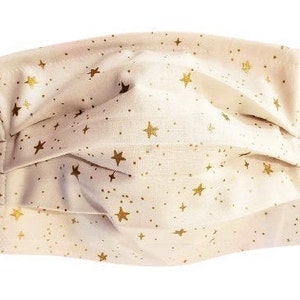May include: A white face mask with a gold star pattern. The mask is pleated and has elastic ear loops.