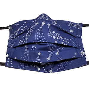 May include: A blue face mask with a white shooting star pattern. The mask has elastic ear loops.