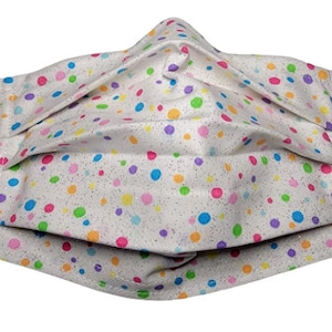 May include: White face mask with a colorful polka dot pattern. The dots are various shades of pink, blue, green, yellow, and orange.