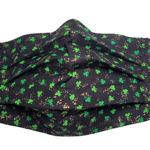 May include: Black face mask with a green shamrock pattern. The shamrocks are scattered on a black background with gold glitter.