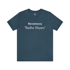 May include: A teal blue t-shirt with the text "Where I come from, we say "Radhe Shyam""