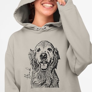 May include: A light gray hoodie with a black and white illustration of a golden retriever dog. The dog's name, "Hank", is written in cursive on the left side of the image.
