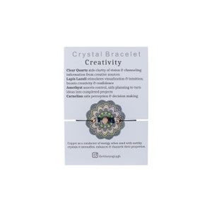 May include: A crystal bracelet with a mandala design and the words "Crystal Bracelet Creativity" on a white card. The card lists the crystals used in the bracelet and their properties: Clear Quartz, Lapis Lazuli, Amethyst, and Carnelian. The card also states that copper is a conductor of energy and enhances the properties of the crystals.