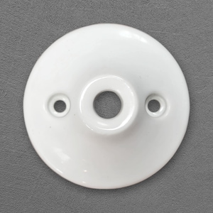 May include: A white, circular ceiling canopy with a central hole and two smaller holes. The canopy has a glossy finish and is designed for electrical fixtures. The design is simple and functional.