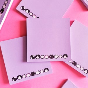 a few of the notepads on pink background