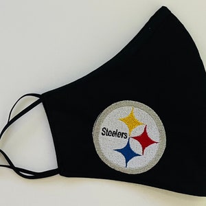 May include: Black face mask with an embroidered Pittsburgh Steelers logo in yellow, red, blue, and white.