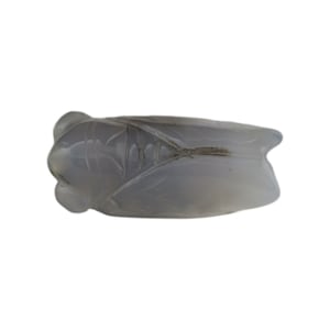 May include: A carved gray agate cicada figurine. The cicada is a symbol of longevity and good luck in Chinese culture.