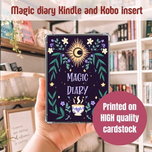 Peut inclure: Une protection pour Kindle et Kobo de couleur violet fonc&eacute; avec l'inscription "Magic Diary". Le design comprend un soleil et une lune, des &eacute;l&eacute;ments floraux et une tasse. Le texte "Printed on HIGH quality cardstock" est &eacute;galement visible.