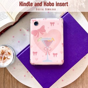 May include: A pink Kindle or Kobo insert with a cocktail design, bows, and a heart. The text "Kindle and Kobo insert" and "Digital Download" are at the top. The insert is on a purple book and a white and wood-grain surface.