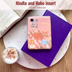May include: A pink Kindle and Kobo insert with a cat illustration, resting on a purple book. The image includes an open book, a candle, and the text "Kindle and Kobo insert DIGITAL DOWNLOAD". The cat is orange with brown stripes, and the insert has a clear case.