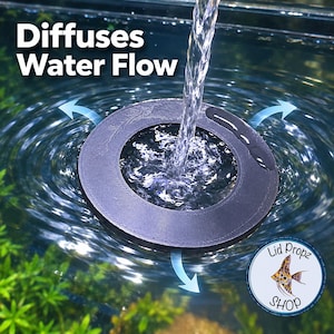 May include: A black circular floating aquarium water flow diffuser with a central opening. The text Diffuses Water Flow is visible in the upper left corner. A circular logo with an angelfish illustration and the text Lid Propz SHOP is present.