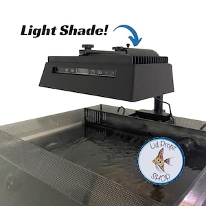 May include: Black aquarium light fixture with a digital display and controls. The light is mounted above a black aquarium with a black mesh lid. The light is adjustable and can be tilted up or down. The light is labeled "Light Shade!" and has a blue arrow pointing to the light. The aquarium has a sticker on the side that says "Lid Propz Shop".