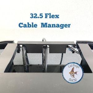 May include: A black cable management system for a computer case. The system is labelled "32.5 Flex Cable Manager". A sticker with a fish and the text "Lid Propz Shop" is visible on the case.