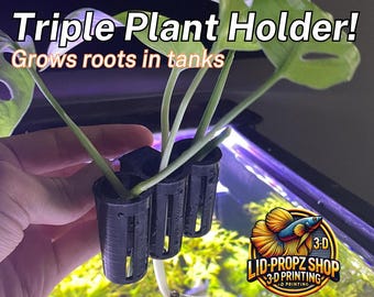 May include: A black plastic triple plant holder with three cylindrical compartments. The holder is attached to the side of a glass aquarium with a green plant growing through it. The text "LID-PROPZ SHOP 3-D PRINTING" is visible on the aquarium.