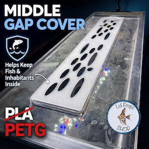 Op de afbeelding: Een doorzichtige aquariumafdekking voor de middelste opening met een wit rechthoekig inzetstuk met ovale ventilatieopeningen. De tekst luidt MIDDLE GAP COVER, Helps Keep Fish & Inhabitants Inside, PLA en PETG. Een rond logo toont een vis.