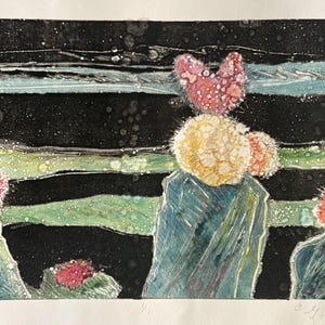 May include: A print featuring three green cacti with vibrant red and yellow spherical tops against a dark, horizontal-striped background. The artwork includes a signature and the handwritten title "Dancing Cactus #14" at the bottom.