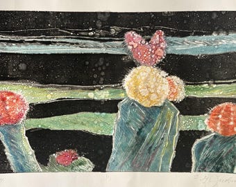May include: A print featuring three green cacti with vibrant red and yellow spherical tops against a dark, horizontal-striped background. The artwork includes a signature and the handwritten title "Dancing Cactus #14" at the bottom.