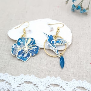 Mismatched asymmetrical hummingbird bird and hibiscus flower earrings in blue liberty Margareth Annie fabric and stainless steel