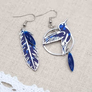 Asymmetrical mismatched hummingbird and feather earrings in liberty capel indigo fabric and silver stainless steel