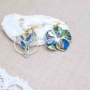 Asymmetrical mismatched hummingbird and hibiscus earrings in liberty fabric Strawberry thief denim and gold stainless steel