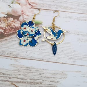 Mismatched asymmetrical hummingbird and cherry blossom earrings in Mitsi deep blue liberty fabric and gold-plated stainless steel