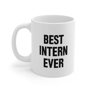 May include: White ceramic coffee mug with black text that reads "BEST INTERN EVER".