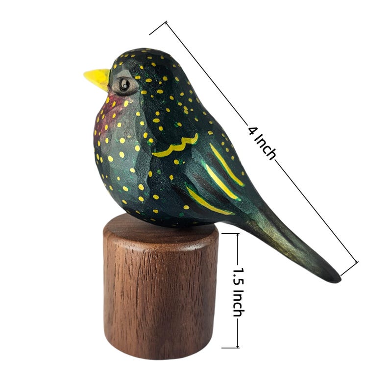 May include: A hand-carved wooden bird figurine, approximately 10 cm long, perched on a 4 cm wooden base. The bird is painted dark green with yellow and red accents, and yellow polka dots. The beak is yellow.