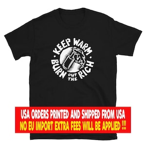 May include: A black short-sleeved t-shirt featuring a white circular graphic on the chest. The design depicts a bottle with flames and the text "KEEP WARM BURN THE RICH" arranged in a circle around the central illustration of the bottle.