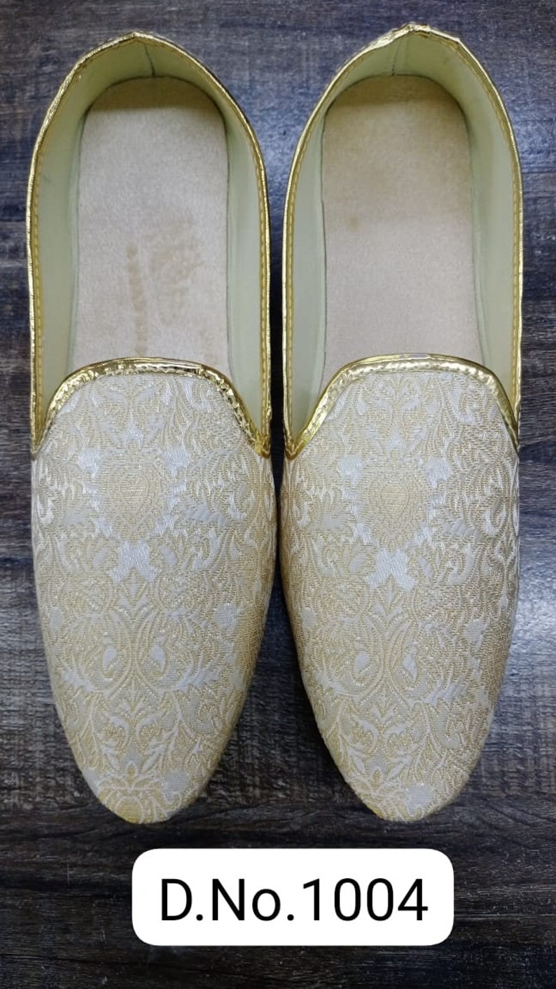 May include: A pair of white and gold embroidered slippers with a gold trim. D.No.1004