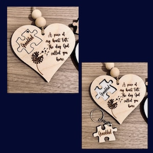 May include: A wooden heart-shaped ornament with a puzzle piece cutout that says "Granddad". The ornament has a dandelion design and the text "A piece of my heart left. The day God called you home."