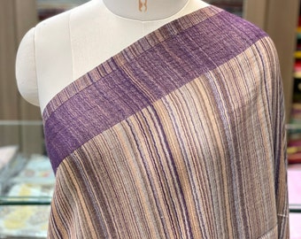 May include: A striped fabric with a purple border. The fabric is draped over a white dress form.