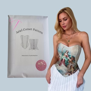 Puede incluir: Un sobre de envío blanco etiquetado Ariel Corset Pattern by TaylorJeanCox con un dibujo lineal de un corsé, junto a un top tipo corsé sin tirantes con una pintura de estilo renacentista de figuras en el cielo, usado con una falda blanca.