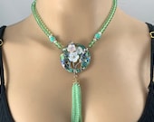 Striking boho chic light green beaded necklace set with abalone and beaded tassel drop