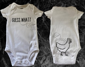 May include: White baby onesie with the text "GUESS WHAT? Kelly" on the front and a black outline of a chicken on the back.