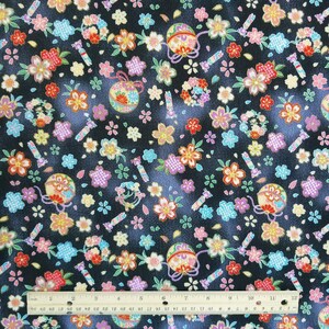 May include: Black fabric with a repeating pattern of colorful flowers, small balls with gold accents, and candy canes. The fabric is textured and has a subtle sheen.