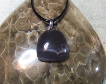 Unique and beautiful Freeform Shaped Purple Swirl Leeland Michigan Slag glass. With silver plated bail and leather cord.