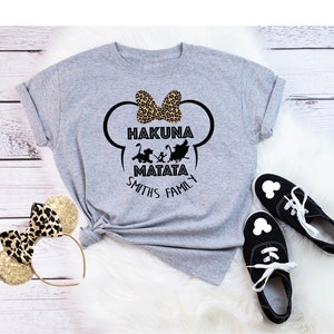 May include: Gray t-shirt with a black and white graphic of Mickey Mouse ears with a bow and the text "Hakuna Matata Smiths Family".