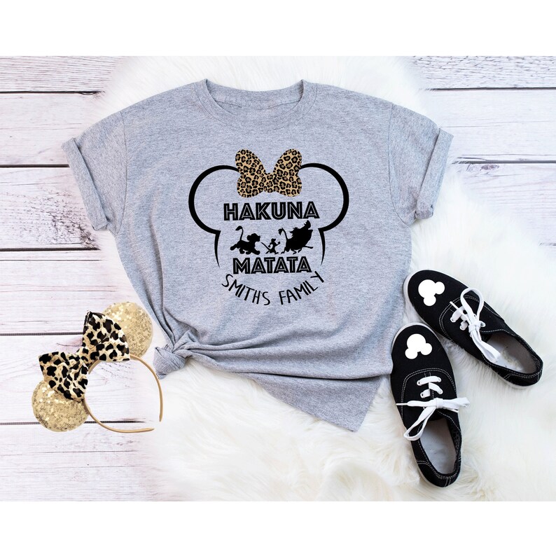 May include: Gray t-shirt with a black and white graphic of Mickey Mouse ears with a bow and the text "Hakuna Matata Smiths Family".