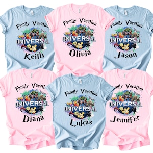 May include: A collection of six short-sleeved t-shirts in light blue and light pink. Each shirt features a graphic of the Universal globe logo surrounded by various cartoon characters, with the text Family Vacation and individual names.