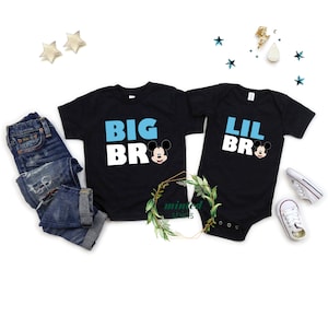 May include: Two black t-shirts with the text "BIG BRO" and "LIL BRO" in white and blue letters. Each shirt features a Mickey Mouse head graphic.