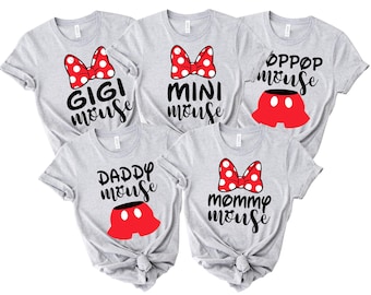 May include: Five light gray t-shirts with black text and red accents. Each shirt features a different phrase: "GIGI mouse", "MINI mouse", "OPPOP mouse", "DADDY mouse", and "mommy mouse". Each shirt has a red bow with white polka dots.
