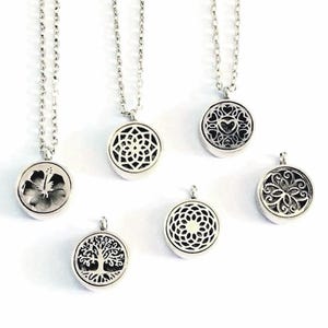 May include: A collection of silver-toned circular pendants, some attached to delicate link chains. The pendants feature intricate cut-out designs including a hibiscus flower, a tree of life, geometric patterns, and heart motifs with dark recessed detailing.