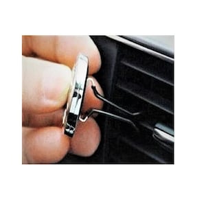 May include: A silver car air freshener with a black clip. The clip is attached to a car air vent.