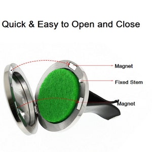 May include: A silver car air freshener with a magnetic lid that opens to reveal a green scented pad. The air freshener has a fixed stem and a magnet on the back for attaching to a vent.