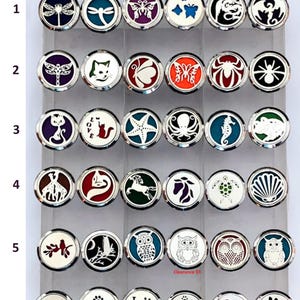 May include: A set of 36 silver car air freshener medallions with various designs, including butterflies, cats, owls, starfish, and paw prints. The medallions are arranged in a grid of six rows and six columns.