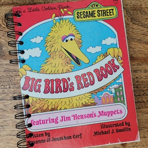 May include: A red spiral bound book with a yellow Big Bird character on the cover. The book is titled "Big Bird's Red Book" and features Jim Henson's Muppets. The book is a Little Golden Book from Sesame Street.